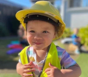 little scholar kid geared up with hard helmet