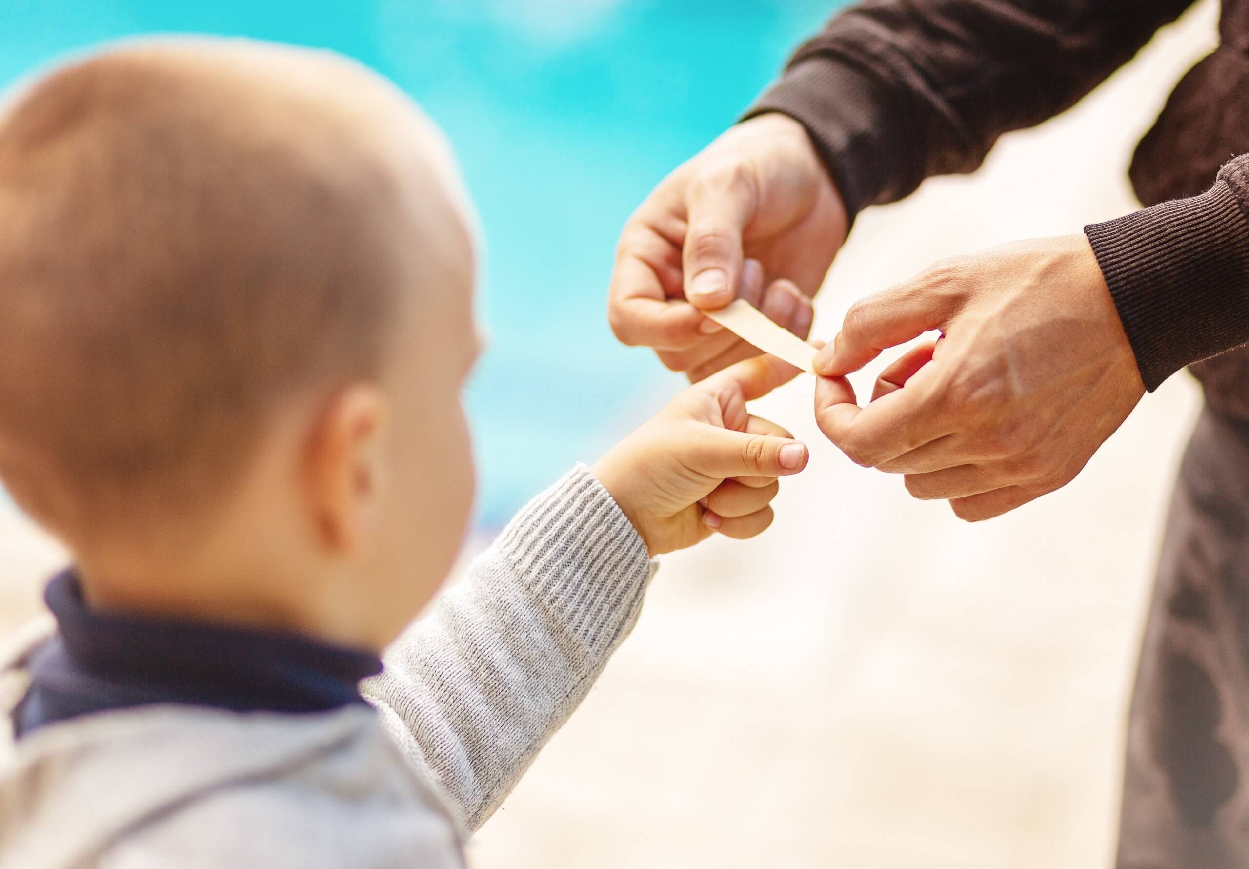 Dad,putting,a,plater,band Aid,on,his,sons,finger,on